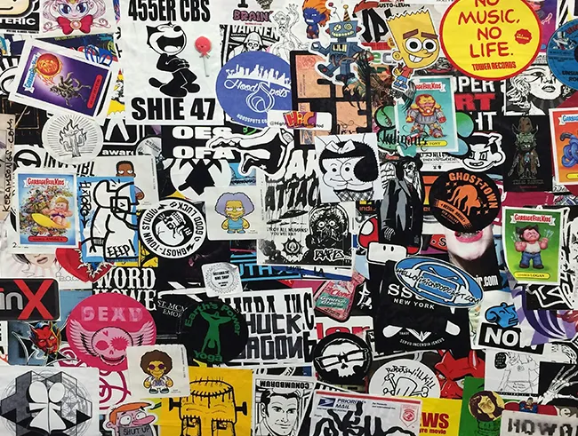 Bunte und dichte Collage aus unzähligen überlappenden Street-Art-Aufklebern, Logos und Comic-Motiven