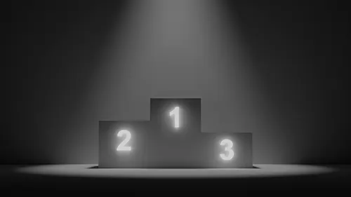 Ein beleuchtetes Siegerpodest mit den leuchtenden Zahlen 1, 2 und 3 im Scheinwerferlicht, das symbolisch für die Top-Positionen im Google Ranking steht.